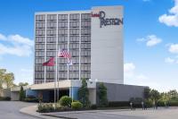 a hotel with two flags in front of a building at Hotel Preston Nashville Airport in Nashville