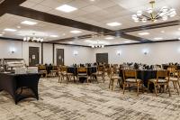 a banquet hall with black tables and chairs at Hotel Preston Nashville Airport in Nashville