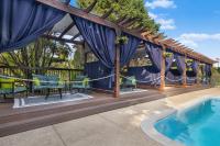 a wooden deck with a pool and a pergola at Hotel Preston Nashville Airport in Nashville
