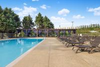a swimming pool with lounge chairs and a bridge at Hotel Preston Nashville Airport in Nashville