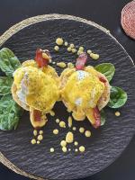 a plate of food with eggs and vegetables on it at Umoya Safari Lodge in Matlhagame