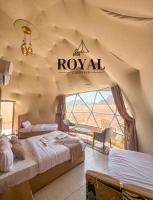 a room with two beds and a sign on the wall at ROYAL luxury rum in Wadi Rum