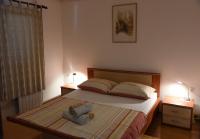 Postel nebo postele na pokoji v ubytování Apartments Ema