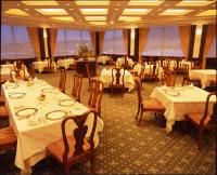 a dining room with tables and chairs with white tablecloths at Hotel Mt. Fuji in Yamanakako
