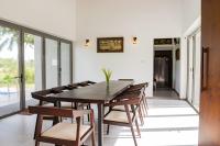 uma sala de jantar com mesa e cadeiras de madeira em Paddy View Garden Resort em Narammala