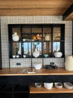 a counter with a bunch of dishes in a kitchen at The Pines Bucegi Lodge in Bran