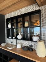 a shelf with vases and other items on it at The Pines Bucegi Lodge in Bran