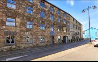 a large stone building on the side of a street at Crew&#39;s Apartment in Dungarvan