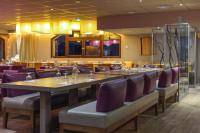 a dining room with a long table and purple chairs at Villages Clubs du Soleil - LES 2 ALPES in Les Deux Alpes