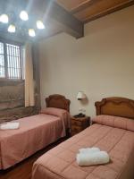 A bed or beds in a room at PICO SACRO II HOTEL Santiago de Compostela