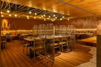 a restaurant with tables and chairs in a room at Hotel Gran Marquise in Fortaleza
