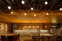 a restaurant with tables and chairs and a kitchen at Hotel Gran Marquise in Fortaleza