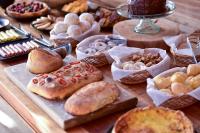 a table topped with different types of pastries and cakes at Parque Nacional EcoResort in Urubici