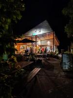 a restaurant with people sitting at tables at night at 't Grote Egeltje XL chalet 220 in Durbuy