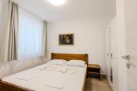 Postel nebo postele na pokoji v ubytování Apartments Lorena