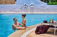 a man and a woman sitting in a swimming pool at Sheraton Samui Resort in Chaweng Noi Beach