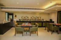 a restaurant with a table and chairs and a counter at Citrus Prime Raipur in Raipur