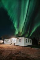 a building with the aurora in the sky at Bjork Guesthouse in Laugarvatn