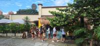 a group of people standing outside of a building at Yolo Hostel Medellin in Medellín