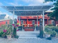 a bench under a pergola in front of a house at Elluk East Studios in Port Vila