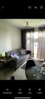 a living room with a couch and a table at Residencial Havaí in João Pessoa