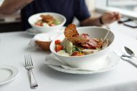 a table with two bowls of food on a table at Riga Islande Hotel with FREE Parking in Rīga