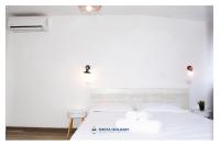 Posteľ alebo postele v izbe v ubytovaní Ostia Holiday Mykonos