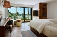 a bedroom with a bed and a desk and a television at Andaz Maui at Wailea Resort - A Concept by Hyatt in Wailea