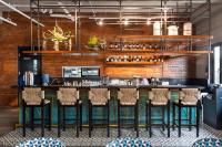 a bar in a restaurant with stools at Bayandati Resort in Bataan