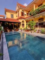 a large swimming pool in front of a house at Tam Coc Family Hotel in Ninh Binh