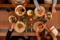 a group of people sitting around a table eating food at Hilton Woking in Woking