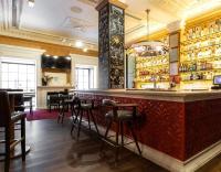 a bar in a restaurant with a red counter at Only YOU Boutique Hotel Madrid in Madrid