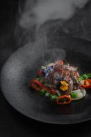 a plate of food on a table with smoke at Guilin Yangshuo Jora Hotel in Yangshuo