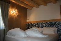 Posteľ alebo postele v izbe v ubytovaní Hotel Orso Grigio