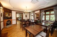 Un comedor con mesas y sillas y una chimenea. en Apartamenty Silva Szklarska Poręba, en Szklarska Poręba