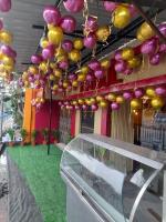 a bunch of balloons hanging from a building at Lodge Babul in Kolkata