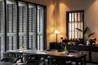 a dining room with two tables and chairs and a window at Rong Unique Hotel-Banyan Lake Scenery in Guilin