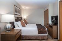 a hotel room with a bed and a television at Sutton Place Hotel Revelstoke Mountain Resort in Revelstoke