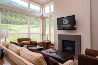 a living room with a couch and a fireplace at Sutton Place Hotel Revelstoke Mountain Resort in Revelstoke