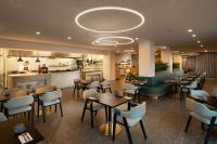 a restaurant with tables and chairs and a bar at DoubleTree by Hilton Hobart in Hobart