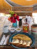 ein Tisch mit einem Teller mit Essen und Brot in der Unterkunft La Casa Colorada in San Benito