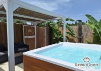 a hot tub in a backyard with a pergola at Giardino D&#39;Oriente in Otranto