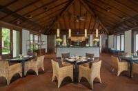 Un comedor con mesas y sillas y una cocina. en The St. Regis Goa Resort, en Cavelossim
