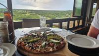 a pizza sitting on top of a table at Elements Private Golf Reserve 109 and or 111 in Moheme