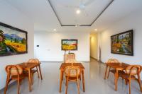 a room with tables and chairs and paintings on the wall at Rahayu Bisma Ubud in Ubud