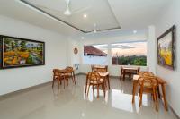 a dining room with chairs and tables and a large window at Rahayu Bisma Ubud in Ubud