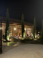 a man sitting in front of a house at night at Villa Corallo in SantʼOmero