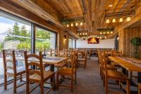 a dining room with wooden tables and chairs at Start Skrzyczne in Szczyrk
