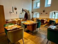a dining room with tables and chairs in a restaurant at Schloss Spangenberg in Spangenberg