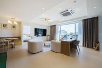 a living room with a desk and a dining room at Gran Hotel in Gunsan